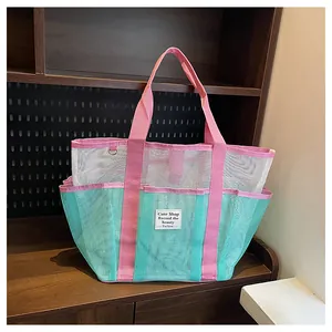 Detail of mesh tote bag showing multi-pocket design and vibrant tricolor mesh texture