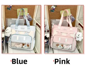 Detail of cute tote bags with clear display windows and white plush dog charms in blue and pink