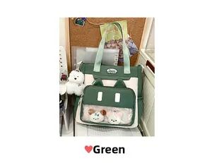 Detail of green and white cat-ear tote bag featuring transparent window and plush bears