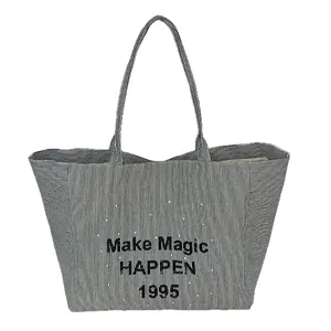 Large striped canvas tote bag with Make Magic Happen print and shoulder straps