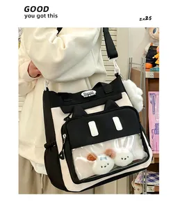 Close-up of cat-ear ita bag showing the transparent window and plush charms