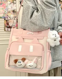 Detailed view of cat-ear tote bag with clear display window and plush dog pendants