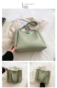 Detail of lucky green PU leather tote bag with silver chain strap and magnetic closure