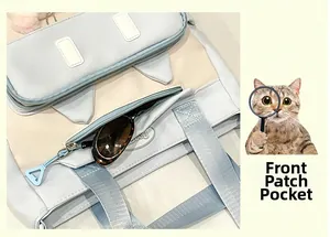Detailed view of cat-ear tote front pocket with light blue contrast and sunglasses inside