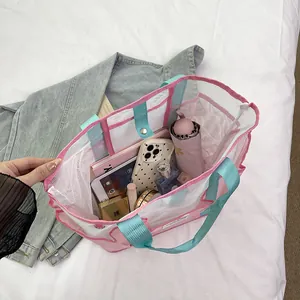 Pink and blue mesh tote bag with multiple compartments showing spacious inner storage