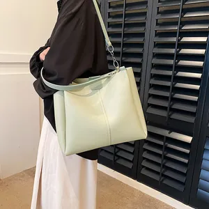 Minimalist mint green large tote bag for women with leather straps and silver hardware
