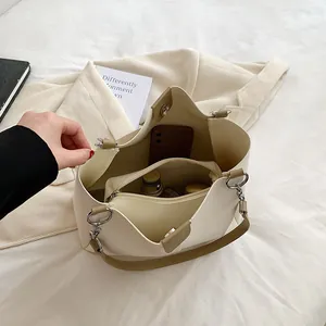 Chic beige PU leather bucket tote bag with brown handles and internal organizer pouch