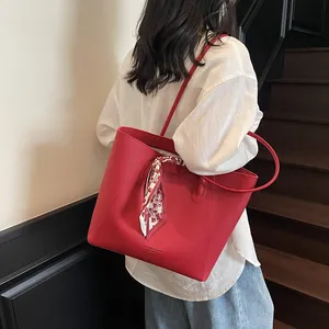 Elegant red litchi texture tote bag with silk scarf decoration and shoulder strap