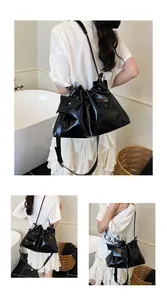 Detail of black glossy patent leather bucket bag with matching mini zip pouch and drawstring