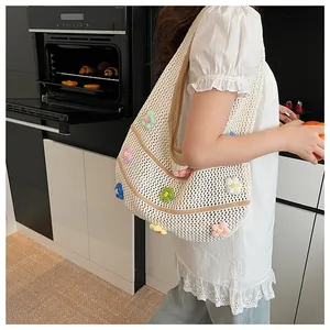 Gros plan détaillé d'un sac cabas au crochet blanc cassé orné de fleurs 3D colorées brodées