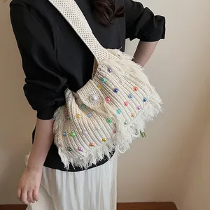 Handwoven cream tote bag with colorful beads and fringe details, bohemian summer style