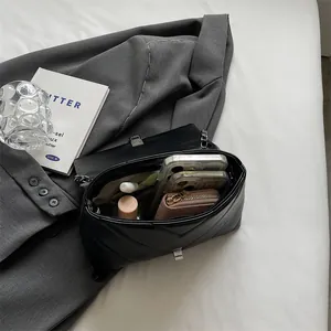 Black V-quilted shoulder bag with silver clasp showing spacious interior storage capacity