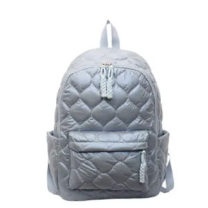 Light blue quilted puffer backpack with soft padded fabric and spacious compartments