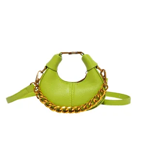 Light green crescent chain handbag in litchi grain leather with gold clasp detail
