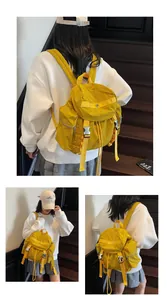 Detail of ginger yellow large-capacity backpack with metal buckle and side zipper pocket