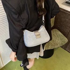 Sparkly light blue crescent underarm bag with rhinestones and silver buckle