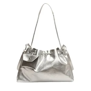Minimalist silver metallic cloud bag with small detachable pouch and thin shoulder straps