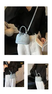 Detail view of light blue shell bag featuring gradient glitter and rhinestone embellishments