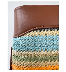 Detail of premium brown leather stitching and colorful woven texture on the bucket bag