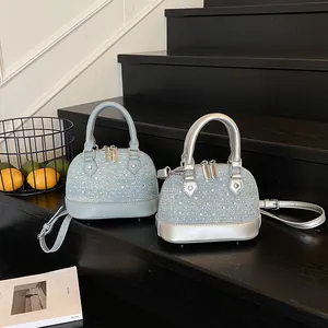 Elegant rhinestone shell bags in blue and silver with metal handles and cross straps