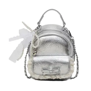 Silver metallic mini bucket backpack with pearl chains and lace bows in sleek design