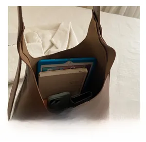 Spacious interior of brown tote bag showing capacity for tablet, phone and wallet