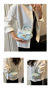 Detail of light blue quilted leather mini bag with gold chain strap and metal lock