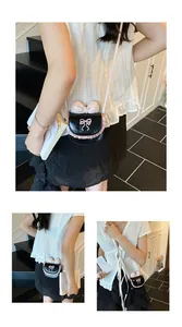 Mini crossbody bag with pink lace trim and bow detail shown on model in natural light