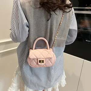 Pink quilted crossbody bag with gold chain strap and elegant turn-lock closure