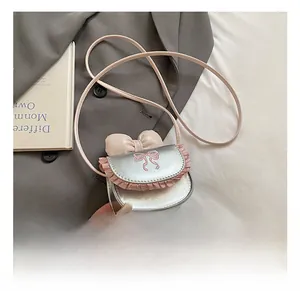 Detail showing silver metallic leather mini bag with pink bow and lace trim decoration