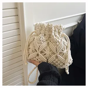 Detail of handcrafted macrame bucket bag showing intricate geometric weave and wood beads