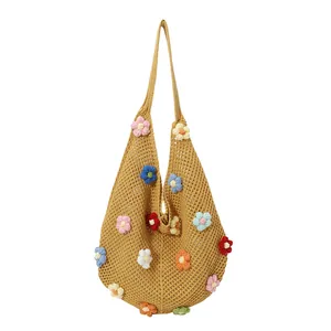 Handmade woven tote bag with 3D crochet flowers in ginger yellow on white background