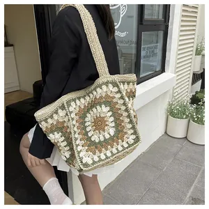 Detailed close-up of handmade crochet tote bag featuring vintage floral knit patterns