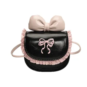 Mini children's crossbody bag with pink lace trim and large leather bow detail