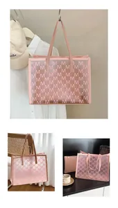 Close-up of pink translucent PVC tote bag with M letter print and matching inner pouch