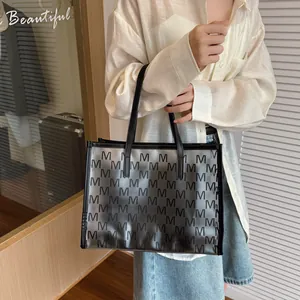 Large jelly tote bag with black M-letter print and comfortable top handles