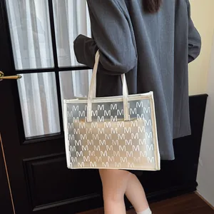 Transparent PVC tote bag with M-letter monogram print and white leather inner pouch