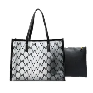 Transparent jelly tote bag with M print and black inner pouch set on white background