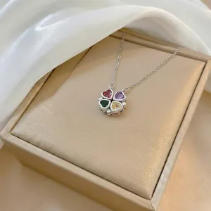 Detail of four-leaf clover necklace with colorful heart stones in a gift box