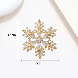 Detailed view of spinning snowflake brooch with gold finish and clear zircons 3.5x3cm