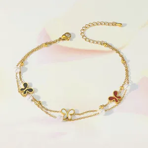 Close-up of double-layer anklet with colorful butterfly charms and small white pearls