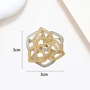 Macro shot of 3cm rotating flower brooch with micro-paved zircons and two-tone metal finish
