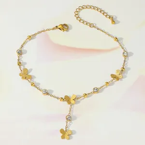 Detail of gold butterfly anklet featuring frosted charms and sparkling zircon stones