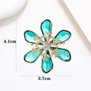 Detail view showing emerald green snowflake brooch dimensions of 4.1cm by 3.7cm