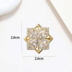 Macro view of 2.6cm snowflake brooch with sparkling cubic zirconia on gold base