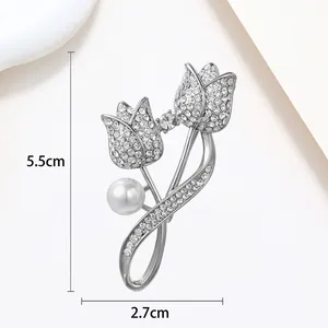 Detailed view of silver tulip brooch with white rhinestones and pearl, 5.5cm height