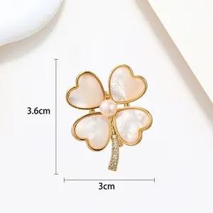 Detailed view of 3.6x3cm clover pearl brooch with shell petals and rhinestone stem