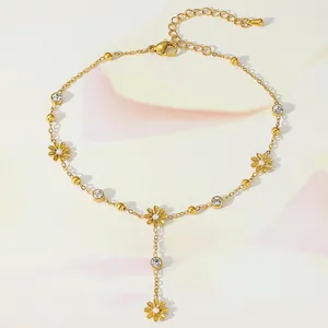 Detailed view of a gold daisy anklet with clear rhinestones and lobster clasp