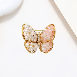 Macro detail of elegant butterfly brooch with pink crystals and white pearls