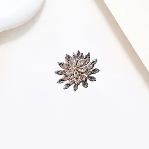Macro detail of rotating snowflake brooch with sparkling crystals in rose gold finish